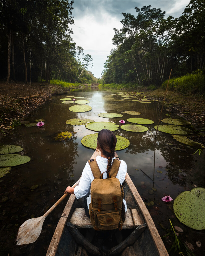 Woman explorer travels an Amazon river in a canoe